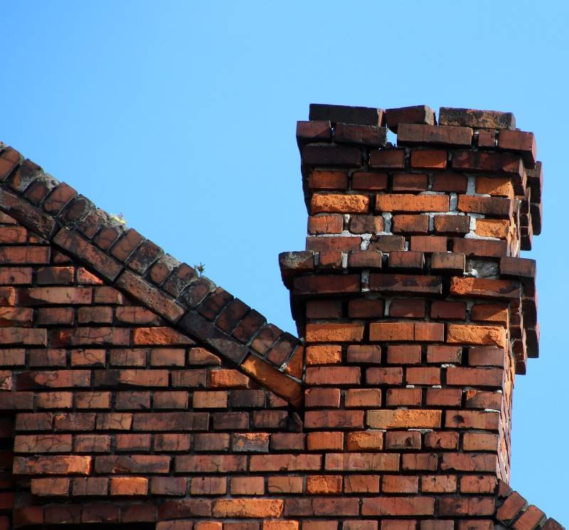 Signs Your Abington Home Needs a Chimney Inspection Blog Article - Damaged chimney on an Abington home showing cracks and missing mortar